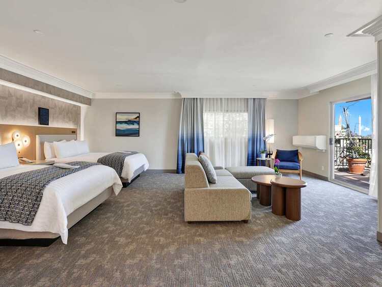 A suite with two queen beds and a seating area