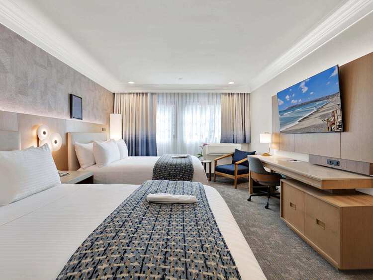A room with two double beds and a desk