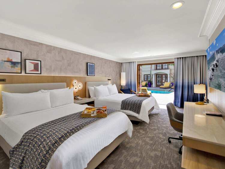 Guest room with two queen beds and a flat-screen TV