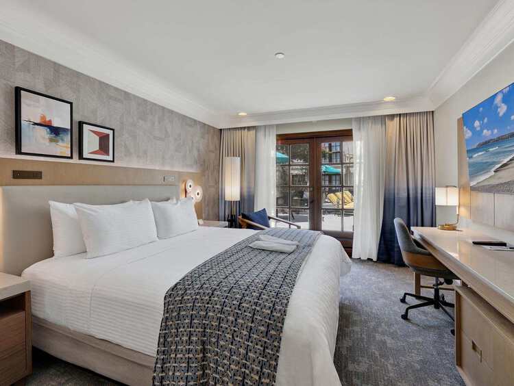 Room with a king bed and a desk