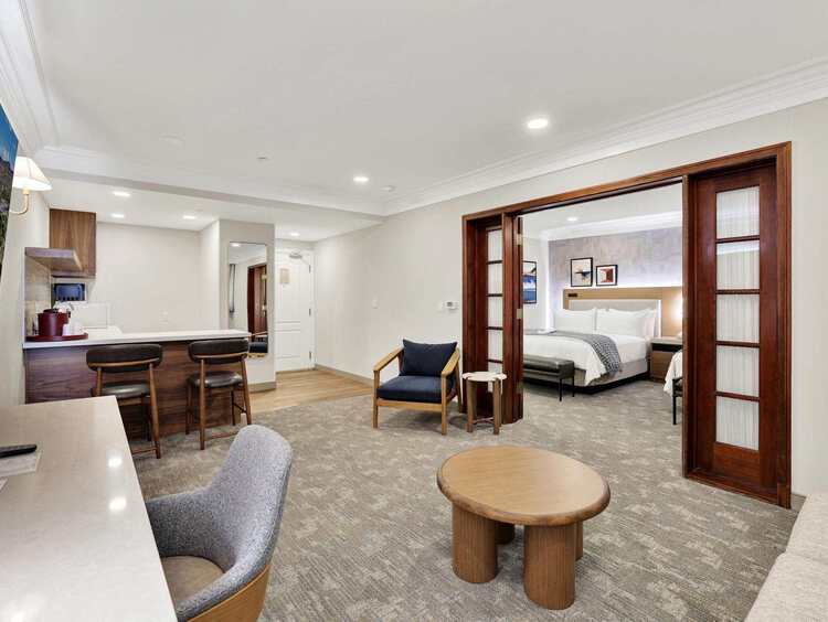 Suite living area with a desk, a kitchen, and a separate master bedroom