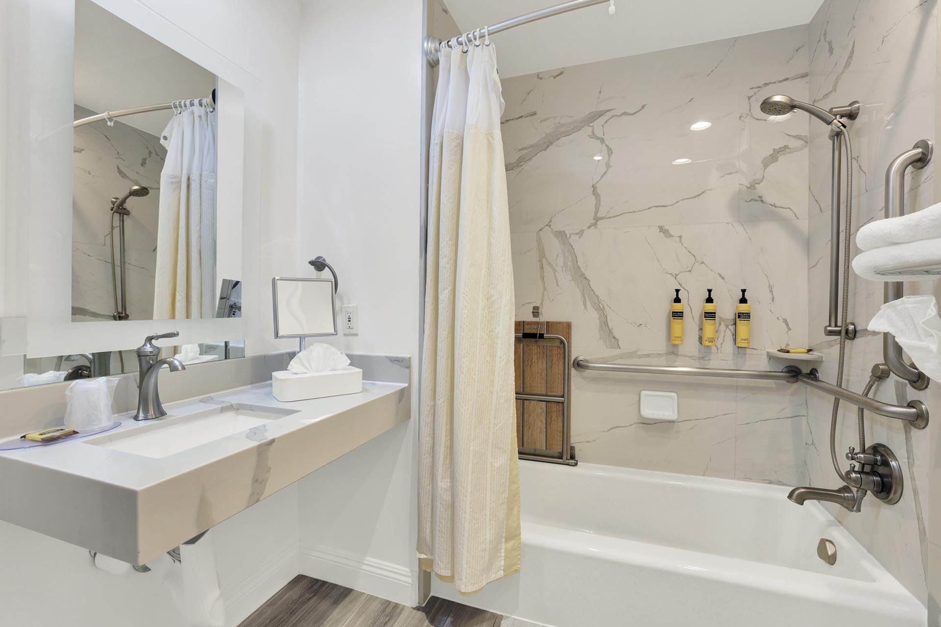 Bathroom with a tub and grab bars