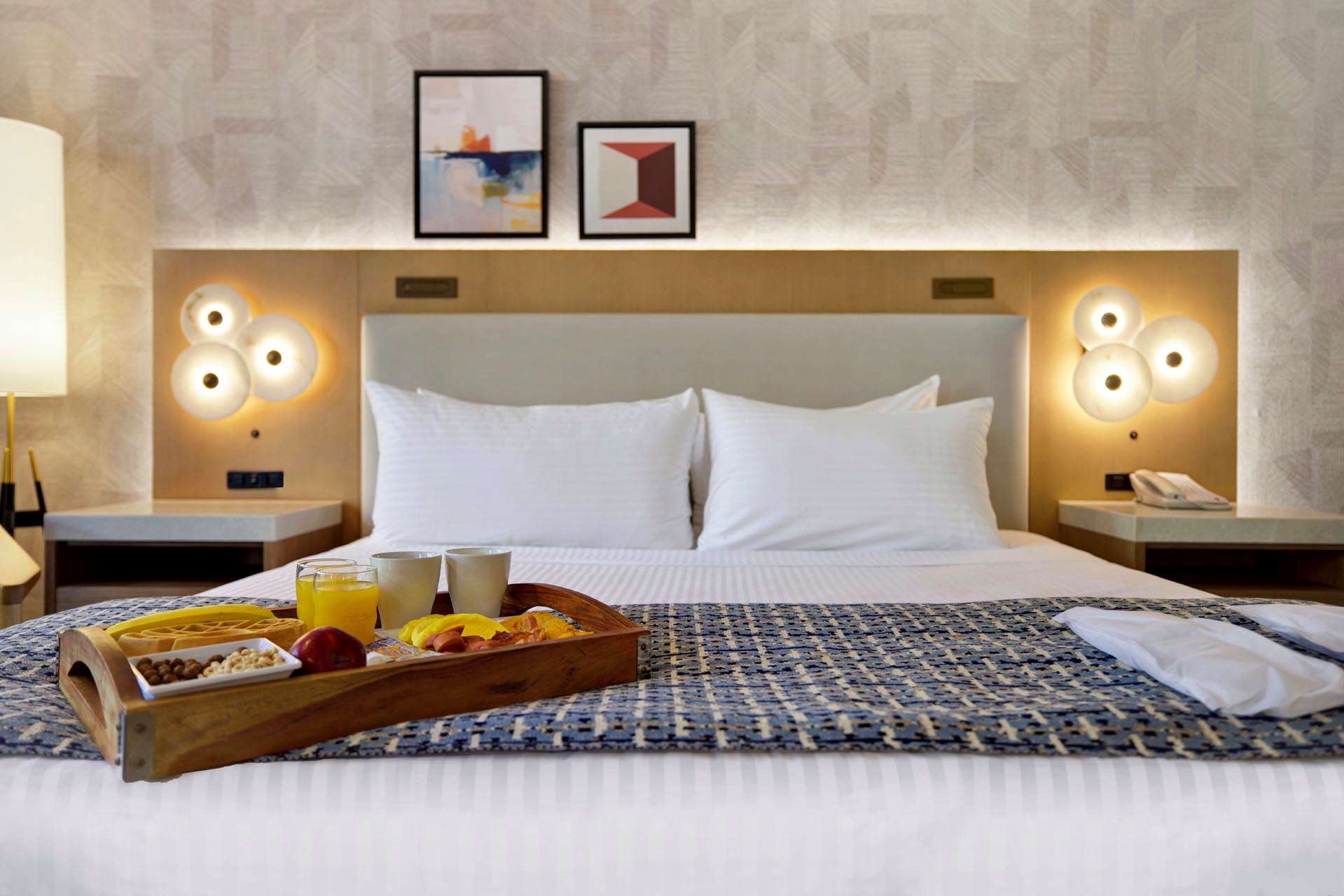 A king bed with a breakfast tray on top