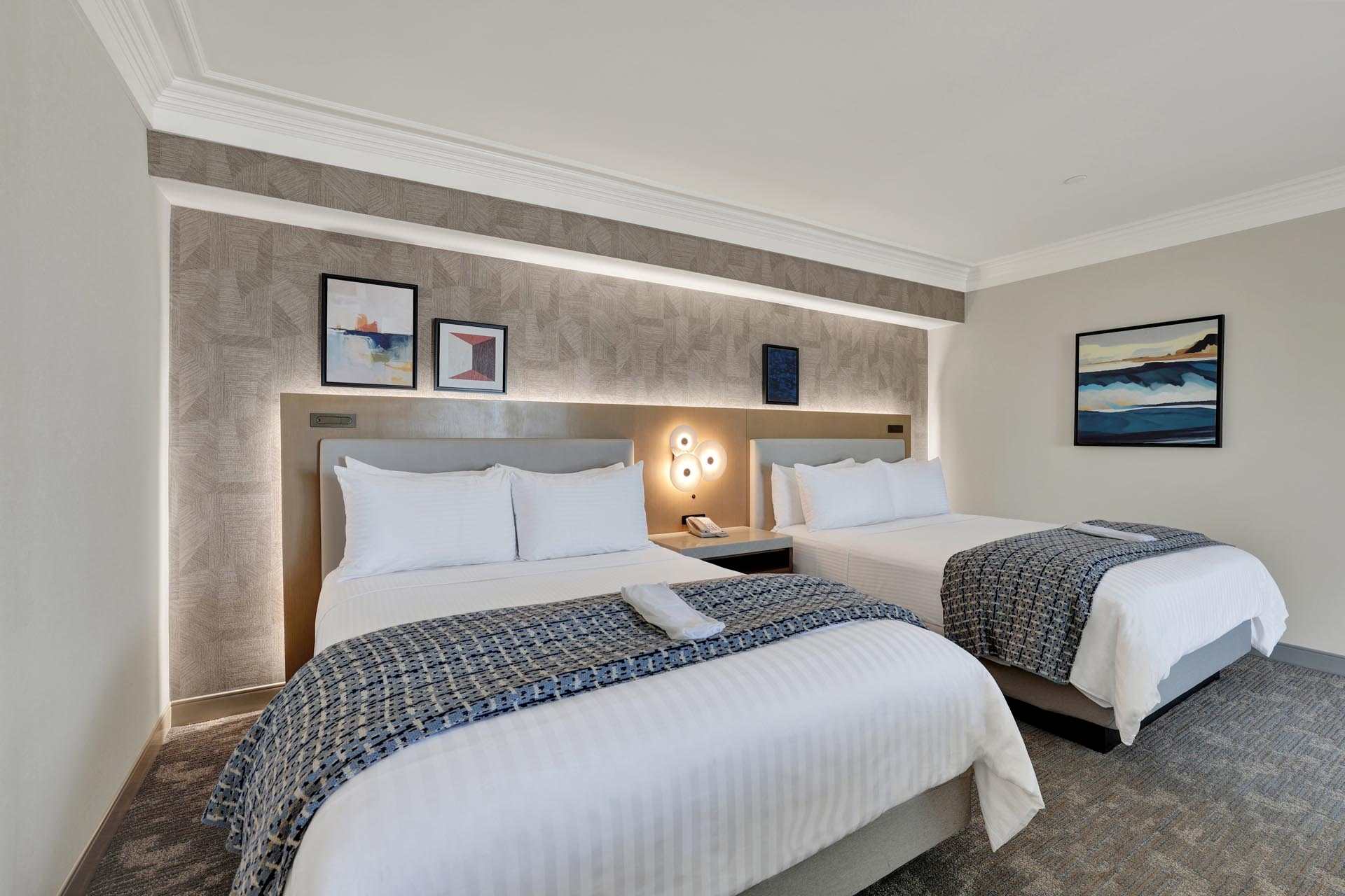 A guest room with two queen beds