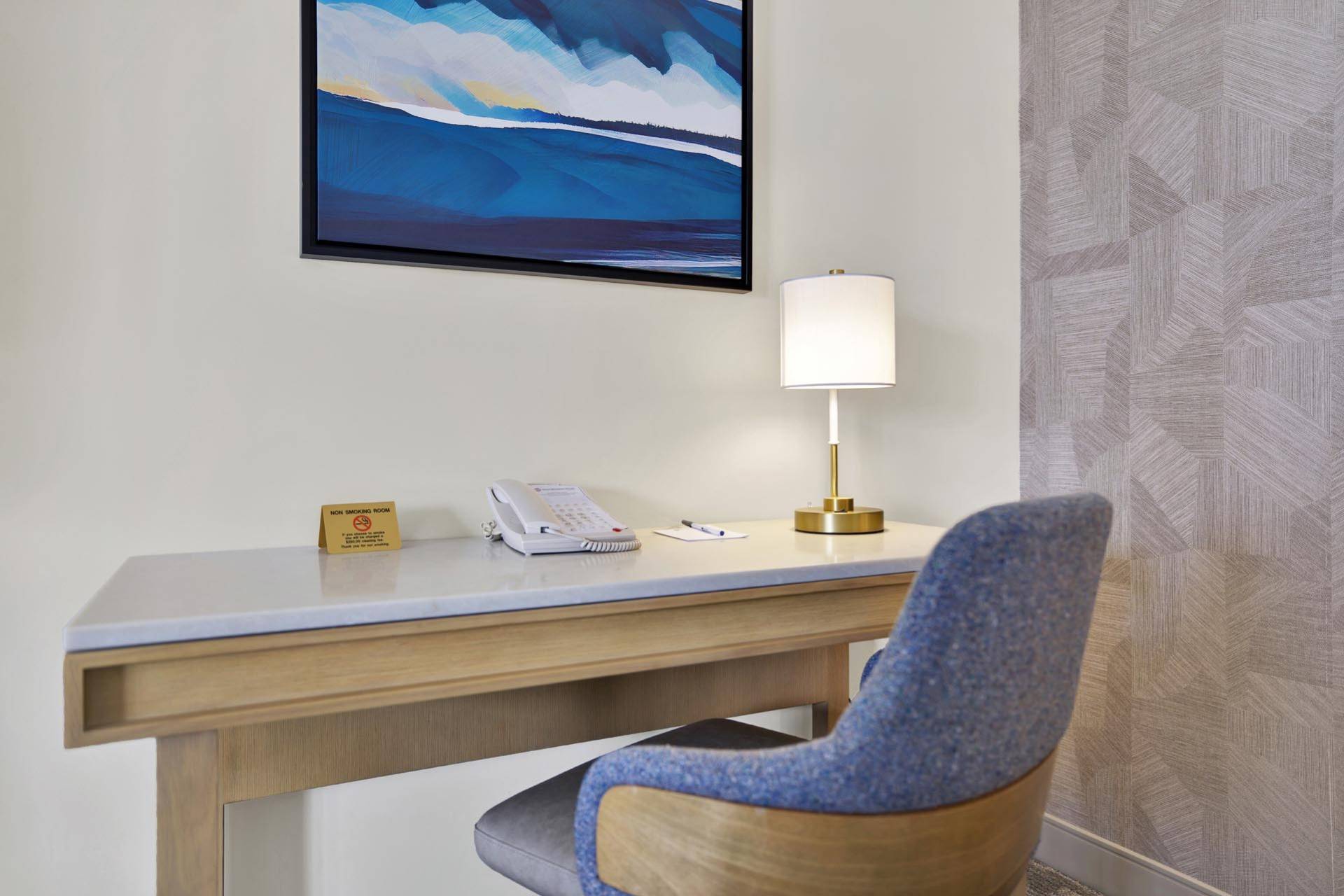 A desk and a blue chair