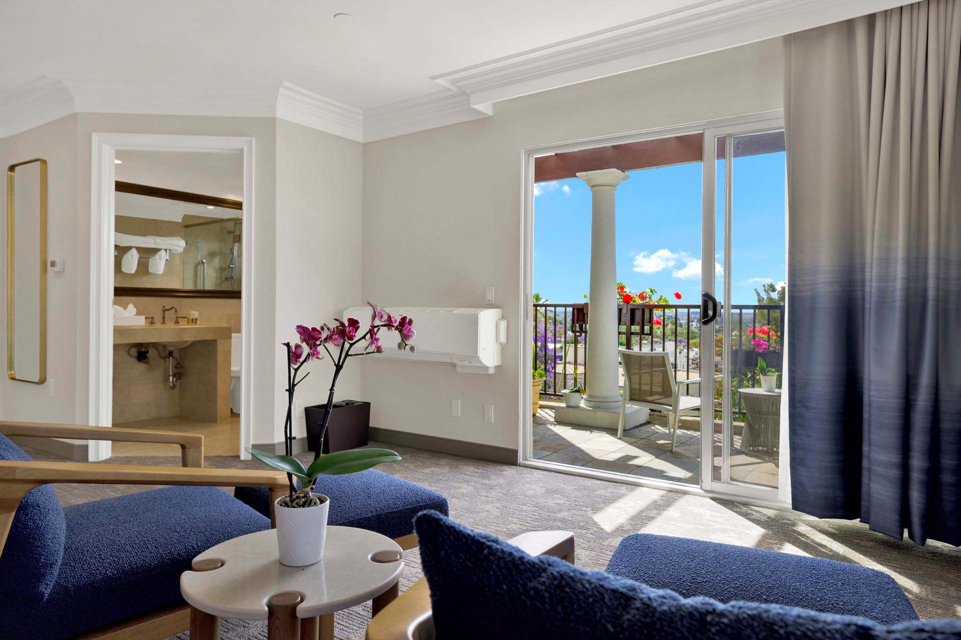Guest room with a seating area and a large balcony window