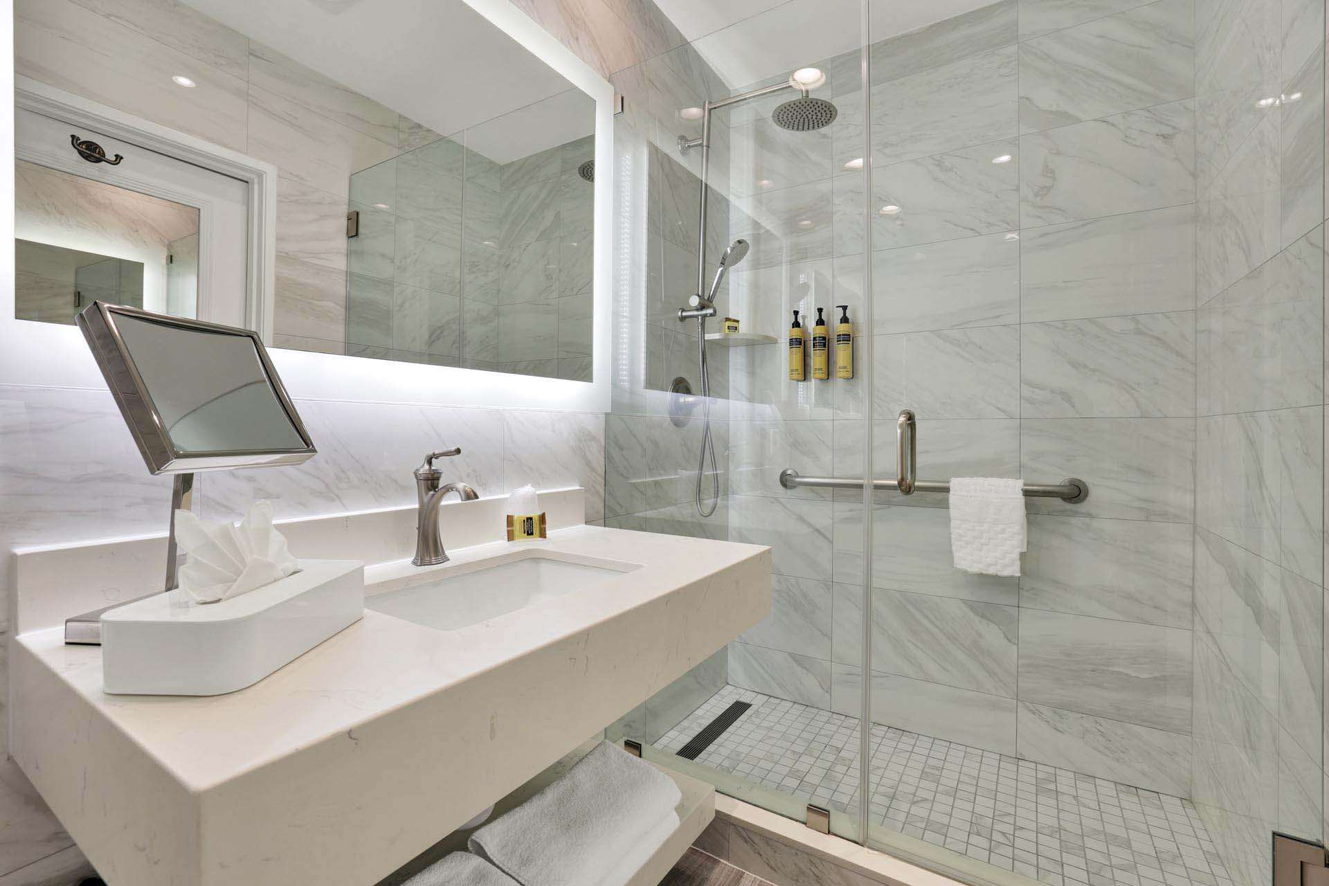 A bathroom with a sink and walk-in shower
