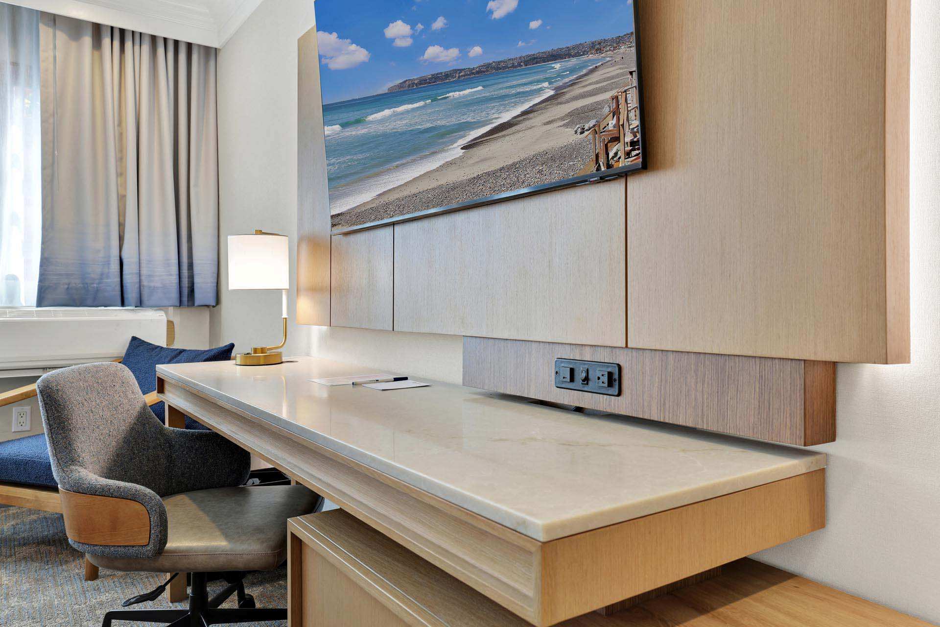A desk and a chair in a guest room