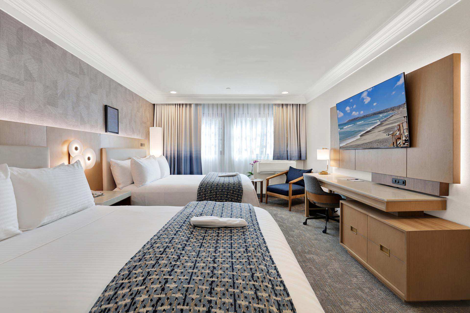 A room with two double beds and a desk