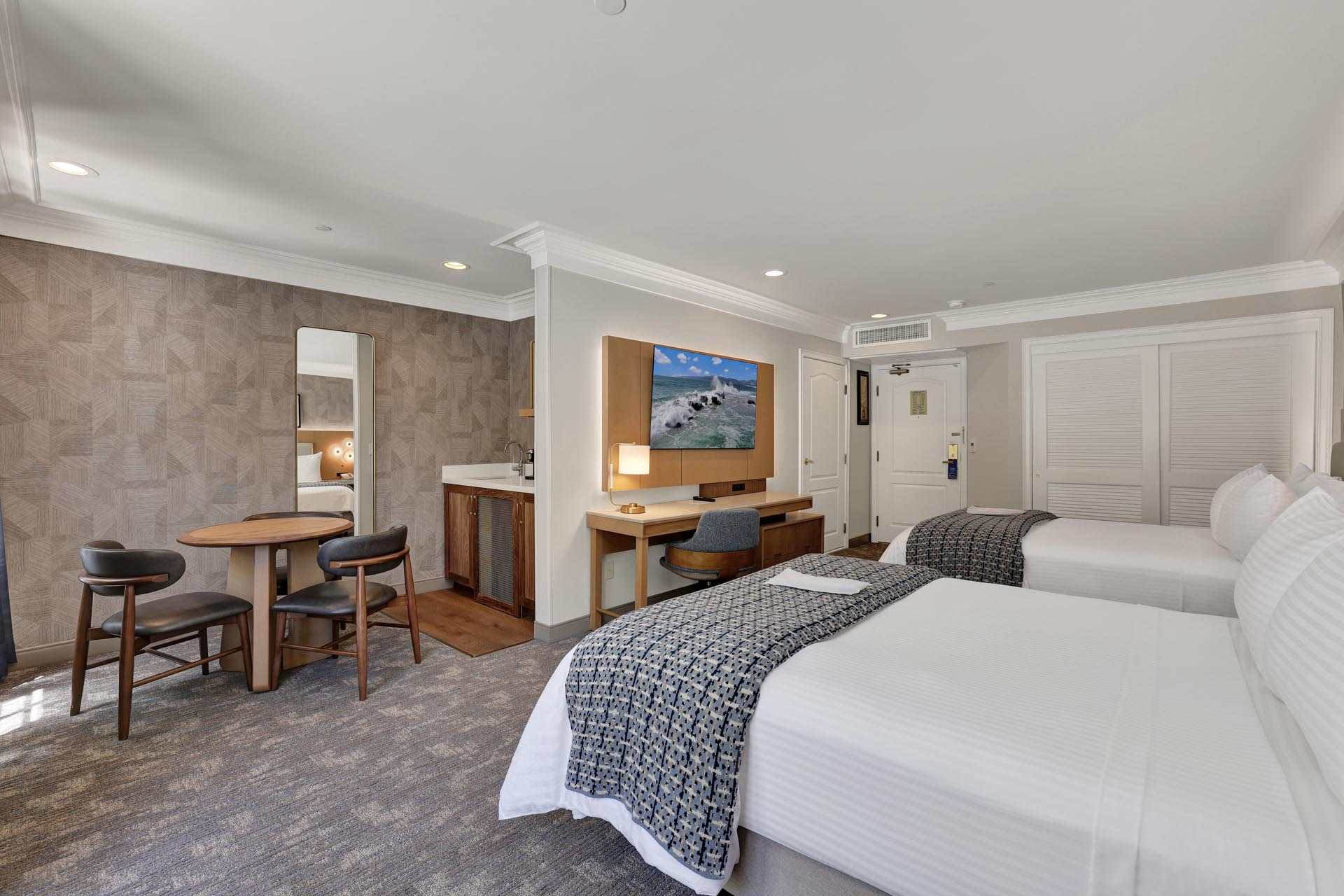 Guest room with two queen beds and a desk