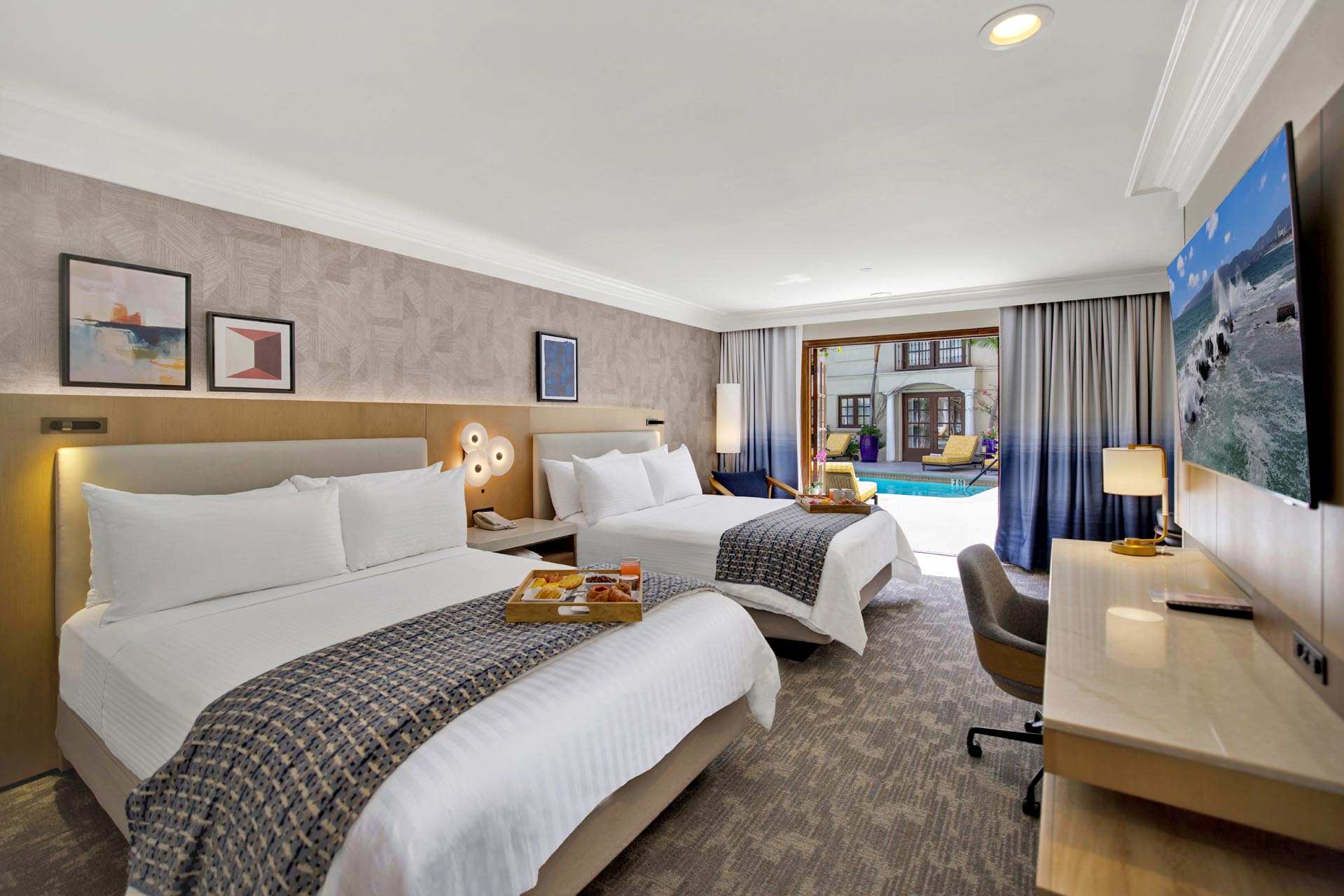 Guest room with two queen beds and a flat-screen TV