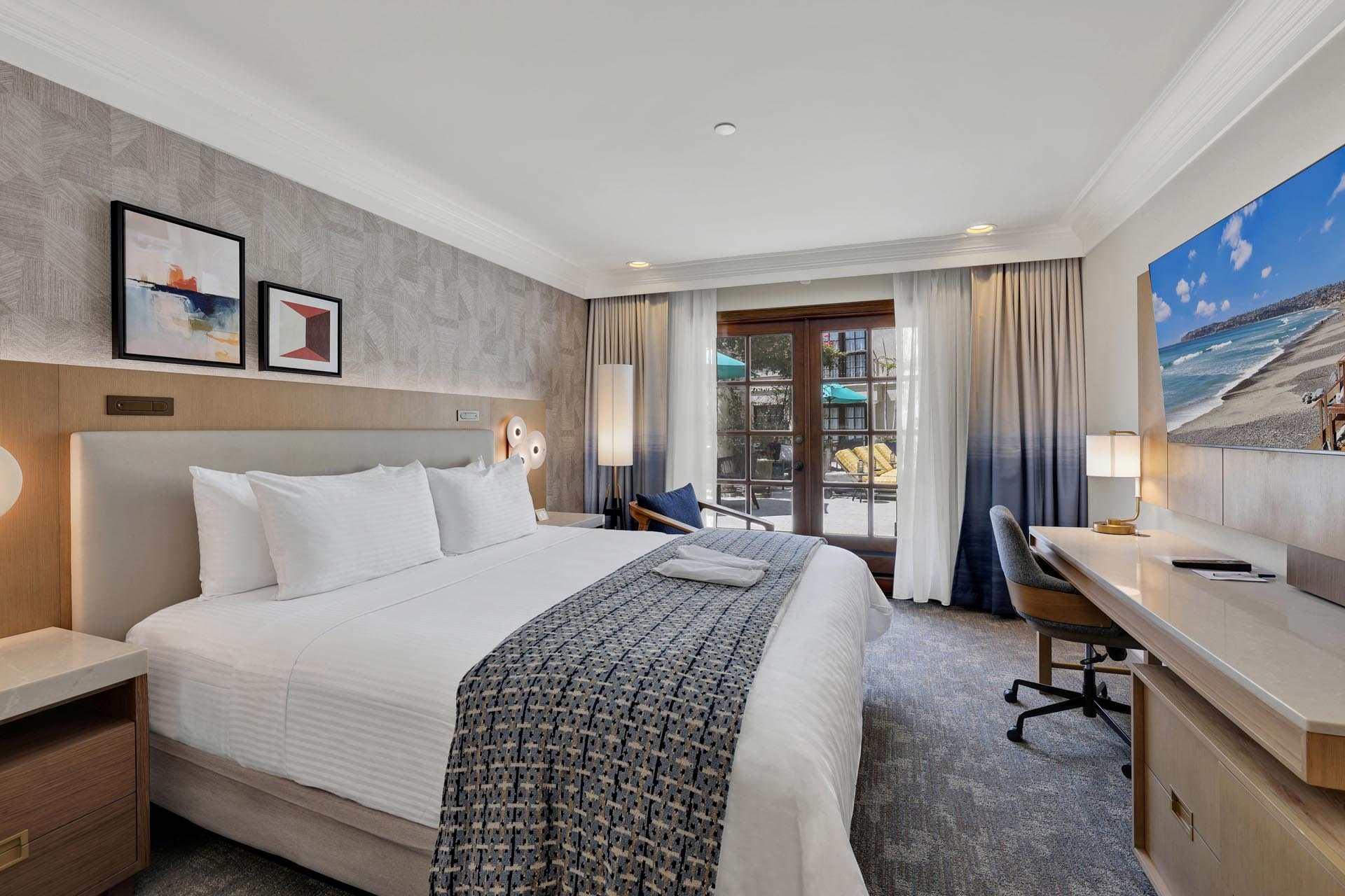 Room with a king bed and a desk