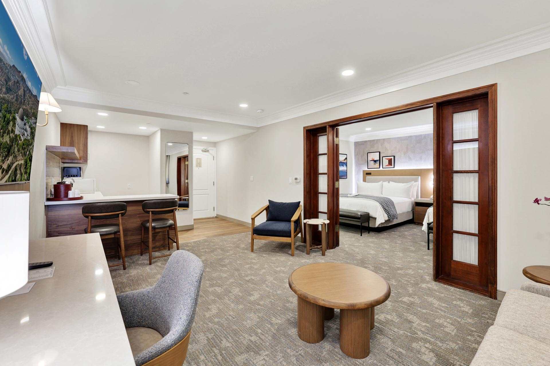 Suite living area with a desk, a kitchen, and a separate master bedroom