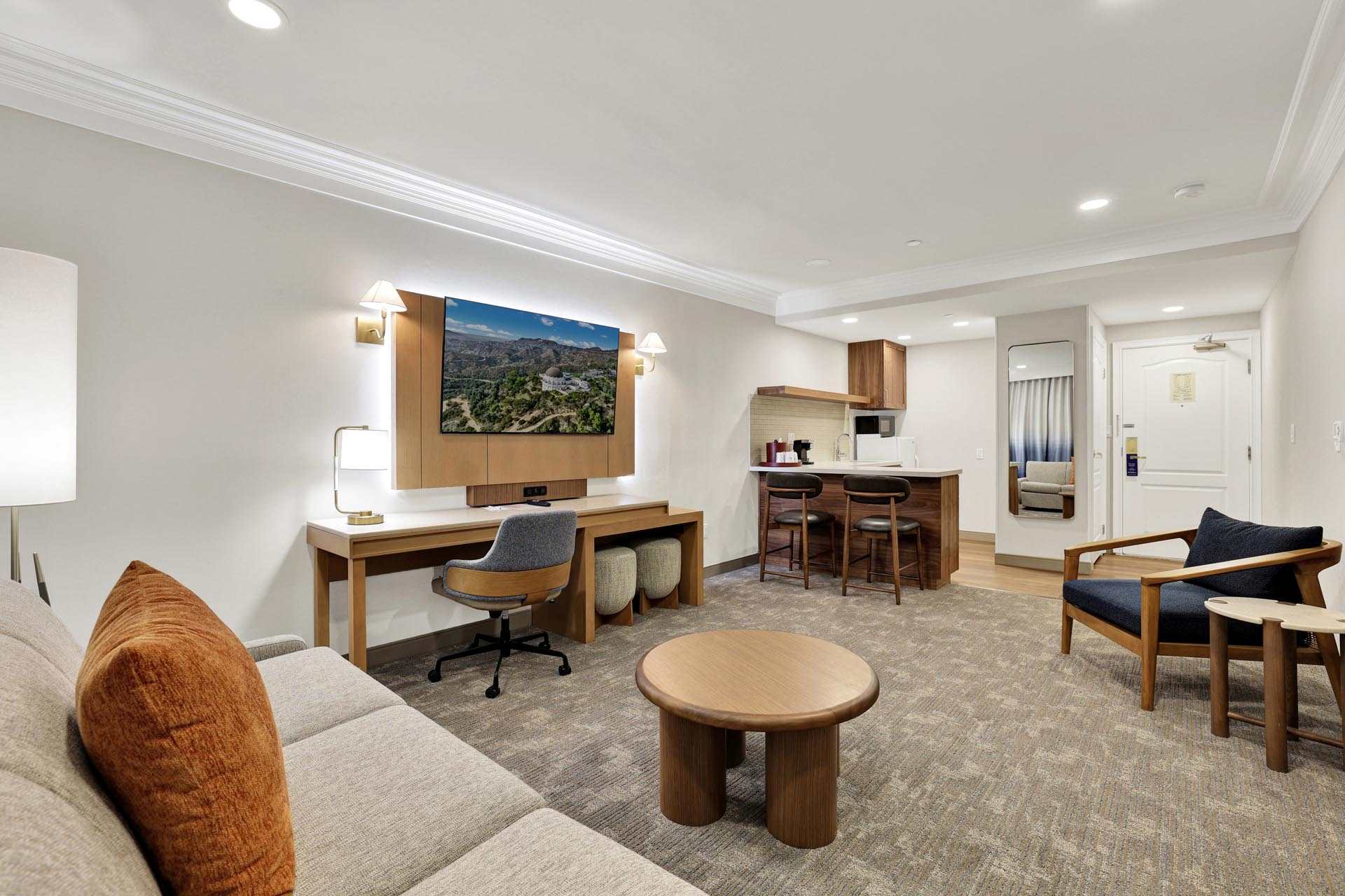 Common area with a sofa, a desk, and an armchair